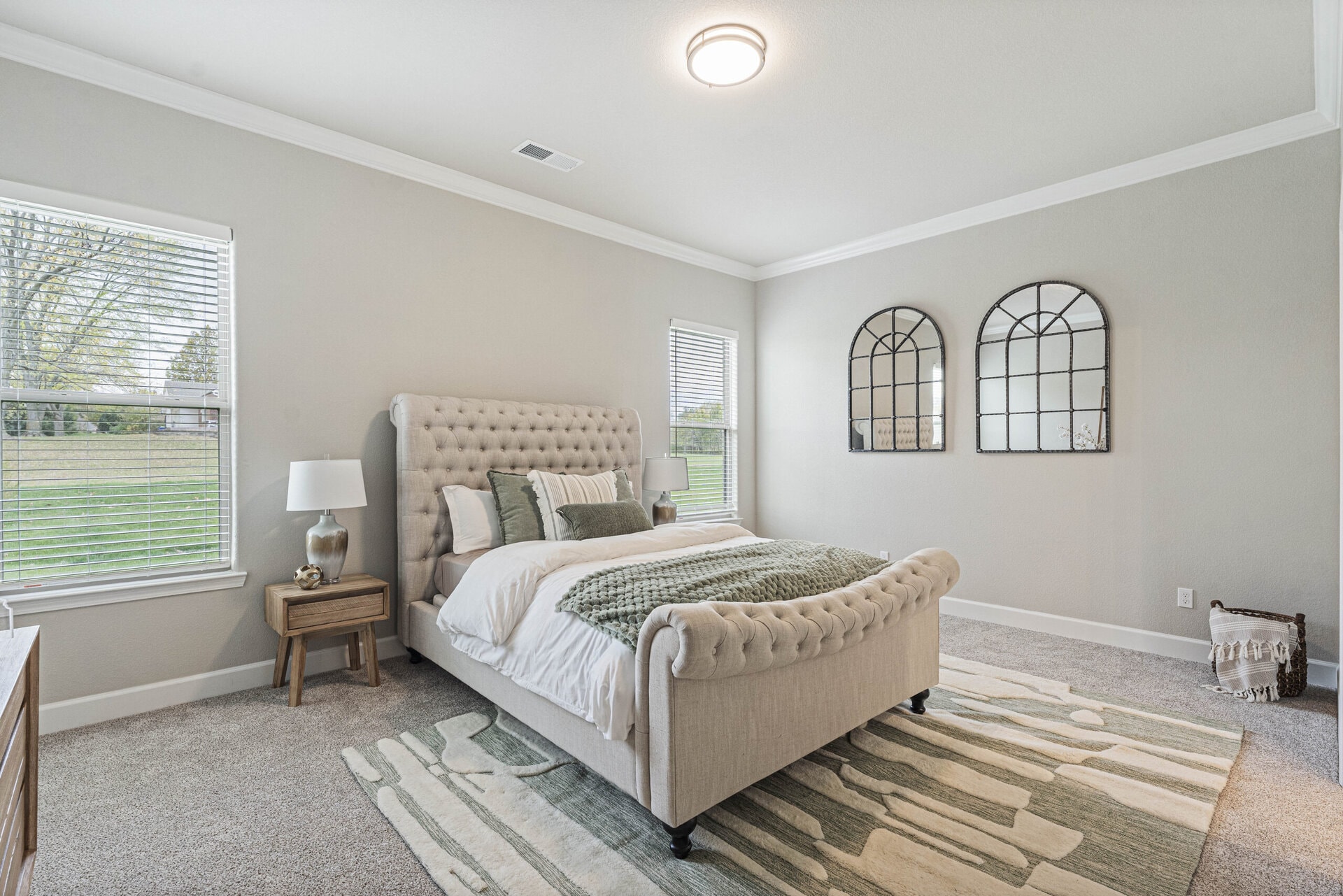 Penelope plan owner's suite with tufted bed and arched mirrors